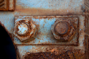 Old steel nut and rusty fixed steel pole
