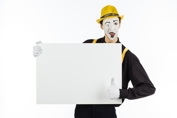 MIME, actor, young man holding white panel with space for text.