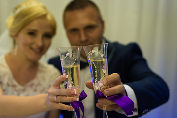 Bride and groom holding glasses of champagne