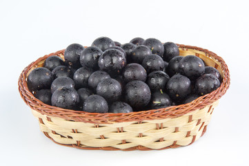 Jaboticaba in a bamboo basket isolated on white background

