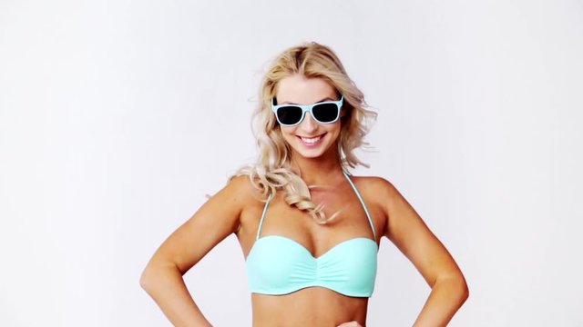 happy woman in bikini swimsuit with sunglasses