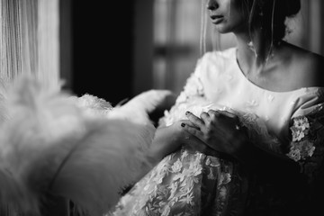 Young beautiful bride in boho style and white feathers.