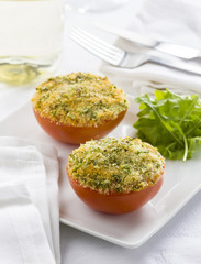 Stuffed tomatoes garnished with provencal herbs.