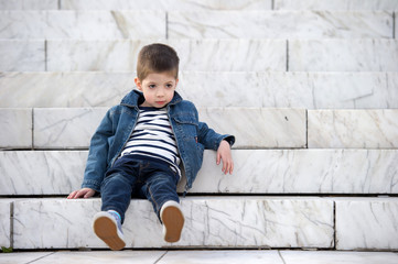 little boy lying on stairs outdoor