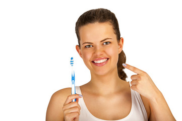 Woman poiting teeth with toothbrush over white background.