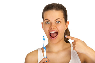 Woman poiting teeth with toothbrush over white background.