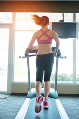 Fototapeta na wymiar woman run on treadmill