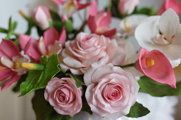 Flowers made from pastry mastic, cake with decorative white