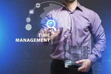 Business, Technology, Internet and network concept. Young businessman working on a virtual screen of the future and sees the inscription: Time management