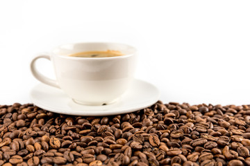 cup of espresso coffee with coffee beans isolated on white with copy space