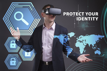 Business, Technology, Internet and network concept. Young businessman working on a virtual screen of the future and sees the inscription: Protect your identity