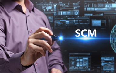 Business, Technology, Internet and network concept. Young businessman working on a virtual screen of the future and sees the inscription: SCM
