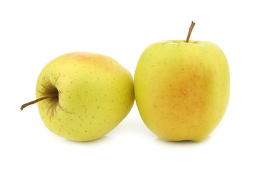 two fresh yellow apples on a white background