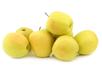 bunch of fresh yellow apples on a white background