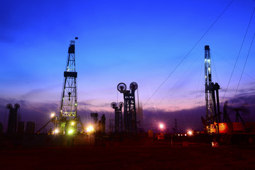 Pumping unit in the work, under the background of the setting sun