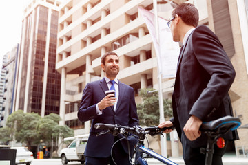 Fototapeta na wymiar Young businessmen with a bike