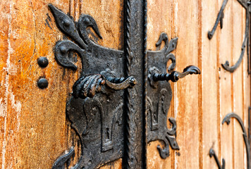 Iron handle on a wooden door of an old church