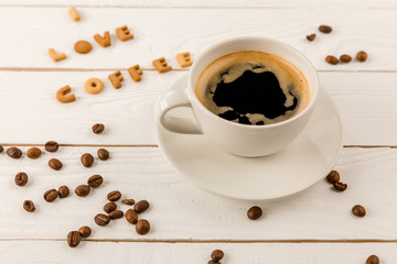 close up view of coffee mug steam and I love coffee lettering on wooden table