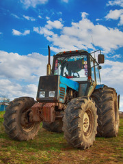 Tractor in the village against the sky