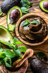 Avocado chocolate mousse on olive wooden board. Top view