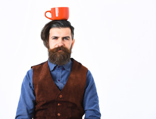 bearded man holding cup with coffee, tea with serious face