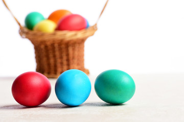 colorful easter eggs in basket isolated on white