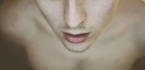 The lower part of the face of a naked man. Male portrait in a futuristic style