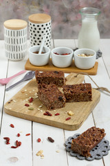 Energy bars with oat, Goji berries, sesame, chocolate and honey. White background, white pottery.