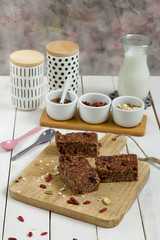 Energy bars with oat, Goji berries, sesame, chocolate and honey. White background, white pottery.