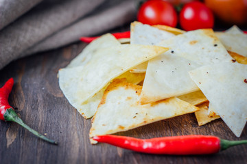 Organic mexican snack - nachos - corn chips with vegetables.