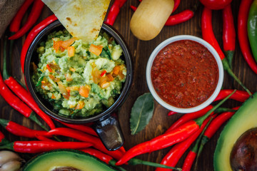 Guacamole and salsa - two hot mexican vegetarian dips.