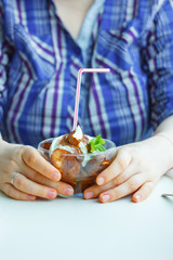 Banana and chocolate dessert in woman hands on a restaurant.
