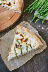 Piece of delicious asparagus pie on list of parchment.