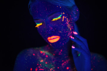 Portrait of Beautiful Fashion Woman in Neon UF Light. Model Girl with Fluorescent Creative Psychedelic MakeUp, Art Design of Female Disco Dancer Model in UV, Colorful Abstract Make-Up