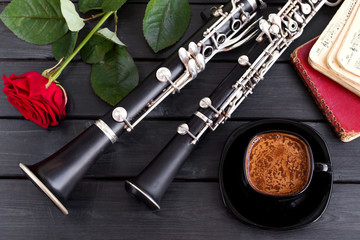 Musical background, poster - oboe, clarinet, rose, coffee, notes, symphony orchestra. Top view....