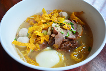 Spicy egg noodle soup with egg and red roast pork
