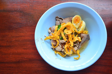 Spicy egg noodle soup with egg and red roast pork