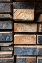 Stack of different size cut wood planks for building construction