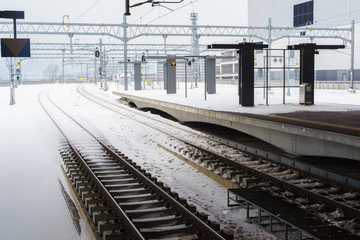 Empty railway and platform covered with snow