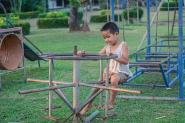 Boy with exercise machines in the park