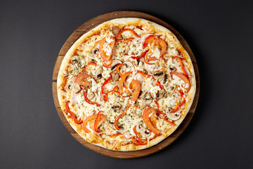 Hot pizza Con Fattoria on a rustic wooden table.