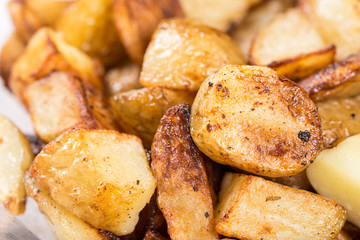 Macro closeup fried young potatoes with blurred background