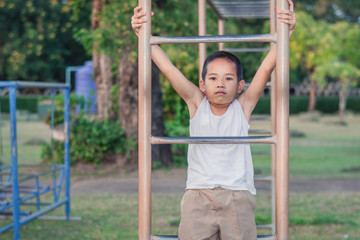Fototapeta premium Boy with exercise machines in the park