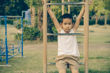 Boy with exercise machines in the park