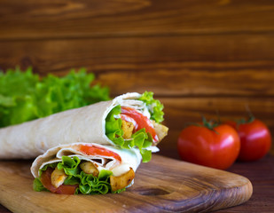 Pita bread with chicken, tomatoes and salad. Shaurma meat. Sandwich for breakfast.