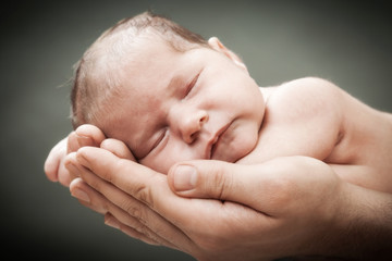 the newborn child on hands