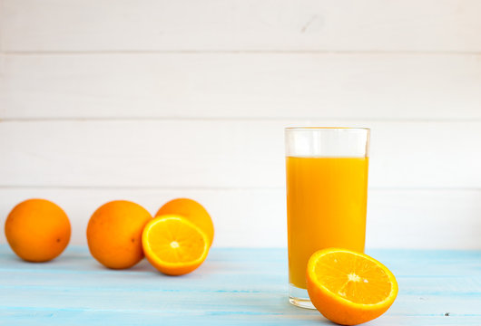 Orange fresh in a glass on a blue background. Fresh, summer juice from oranges