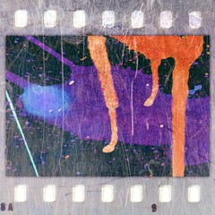 Vintage film strip frame with colorful paint dripping.