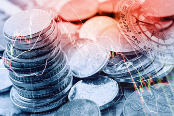 Pile and a stack of coins with technical chart of financial instruments. A concept about currency...