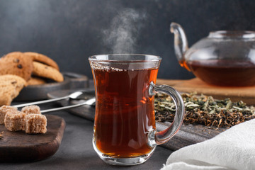 Steaming cup of tea, still life on a dark background